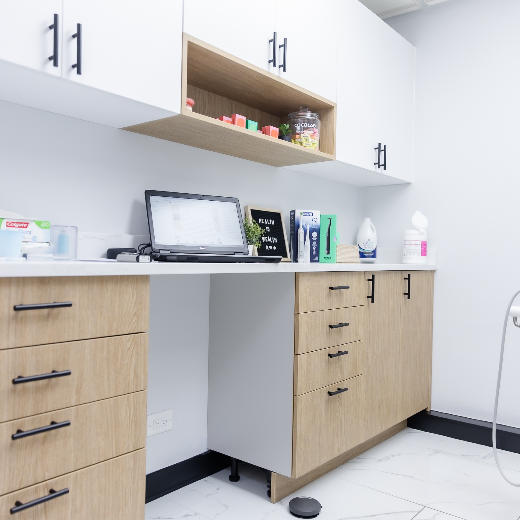 Sterilization and storage area with modern white and wood cabinetry at Ganger Family Dentistry